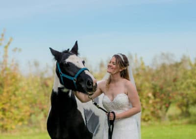 bride with horse , wedding hair and make up by pretty please